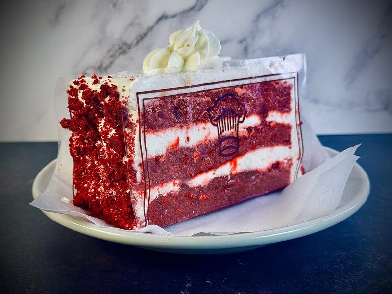 Red velvet cake slice with cream cheese frosting